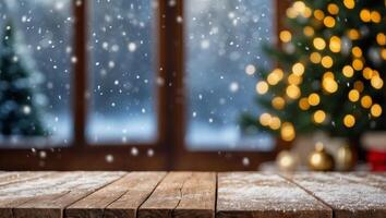 Empty wood table top on blur with bokeh Christmas tree and new's year decoration on window banner background with snowfall - can be used for display or montage your products. photo