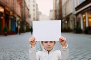 child hand hold blank paper photo