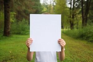 child hand hold blank paper photo