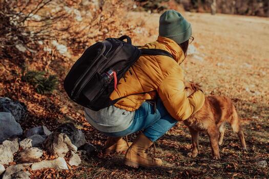 Young woman with dog on a sunny day hiking photo