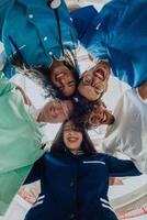 Group of doctors a medical nurse, and a surgeon are captured in a heartfelt embrace, showcasing their unity, teamwork, and profound connection in the healthcare field. photo