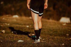 A man stretching after a hard workout in the early hours of the morning photo