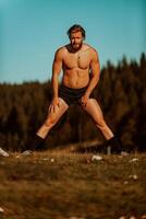 A man stretching after a hard workout in the early hours of the morning photo