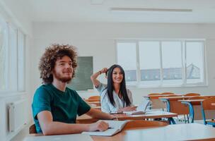 A group of diverse students engages in lively discussion as they educate themselves in a modern classroom, embracing the power of collaboration and knowledge exchange. photo