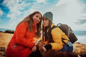 two friends are playing with a dog in nature photo