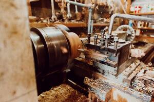 Close-up photo of a lathe working on wood. Mechanical processing of wood