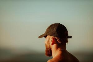 An athlete rests on top of a mountain after exhausting running training. photo
