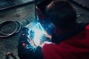 Close up of the steel welding process. Work in the heavy steel industry photo