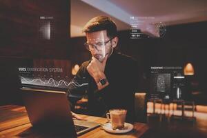 Biometric security, the hologram of online security. Biometric security of eye, voice, finger and face. A man using a laptop in a cafe. photo
