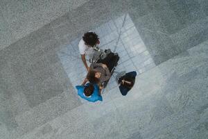 Top view of a group of medics is collaboratively attending to a patient in a wheelchair, demonstrating teamwork and dedication in providing healthcare assistance. photo