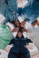 Group of doctors a medical nurse, and a surgeon are captured in a heartfelt embrace, showcasing their unity, teamwork, and profound connection in the healthcare field. photo
