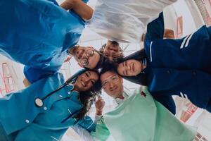 Group of doctors a medical nurse, and a surgeon are captured in a heartfelt embrace, showcasing their unity, teamwork, and profound connection in the healthcare field. photo