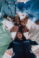 Group of doctors a medical nurse, and a surgeon are captured in a heartfelt embrace, showcasing their unity, teamwork, and profound connection in the healthcare field. photo