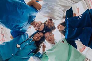 Group of doctors a medical nurse, and a surgeon are captured in a heartfelt embrace, showcasing their unity, teamwork, and profound connection in the healthcare field. photo