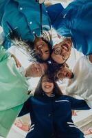 Group of doctors a medical nurse, and a surgeon are captured in a heartfelt embrace, showcasing their unity, teamwork, and profound connection in the healthcare field. photo