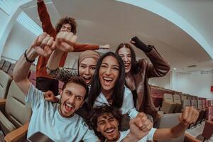In a heartwarming scene, a diverse group of friends gathers around a television, radiating joy and unity as they collectively witness and celebrate a joyful event together. photo