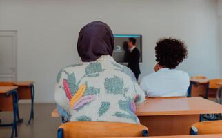 A diverse group of students is attentively listening, actively participating, and embracing modern education in a dynamic classroom setting, fostering collaboration and stimulating creativity. photo