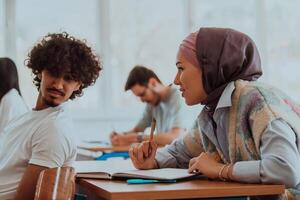A group of diverse students engages in lively discussion as they educate themselves in a modern classroom, embracing the power of collaboration and knowledge exchange. photo