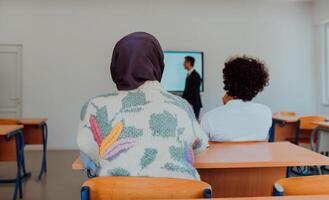 A diverse group of students is attentively listening, actively participating, and embracing modern education in a dynamic classroom setting, fostering collaboration and stimulating creativity. photo