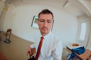 A modernly dressed professor engages in educating students, who listen attentively, creating a dynamic scene of knowledge-sharing and focused learning in the classroom. photo