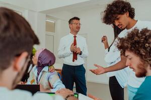 A modernly dressed professor engages in educating students, who listen attentively, creating a dynamic scene of knowledge-sharing and focused learning in the classroom. photo