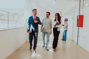 The director conducts a conversation with the secretary and a young programmer in a modern and spacious corridor of a large company, discussing various business topics and projects. photo