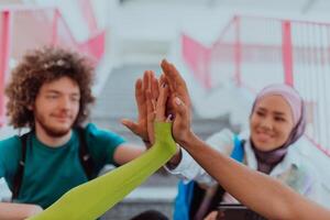 A diverse group of students symbolizes unity as they interlace their hands, portraying a sense of community, collaboration, and inclusive harmony photo