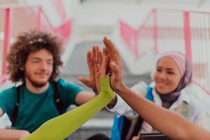 A diverse group of students symbolizes unity as they interlace their hands, portraying a sense of community, collaboration, and inclusive harmony photo