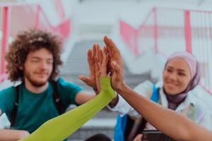 A diverse group of students symbolizes unity as they interlace their hands, portraying a sense of community, collaboration, and inclusive harmony photo