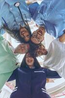 Group of doctors a medical nurse, and a surgeon are captured in a heartfelt embrace, showcasing their unity, teamwork, and profound connection in the healthcare field. photo