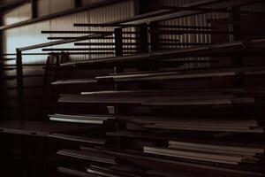 A vast warehouse in the forestry industry, showcasing a plethora of wooden products, including boards and various timber items neatly organized in storage photo