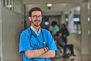 A doctor stands confidently in a hospital hallway with arms crossed, exuding determination and professionalism in the clinical environment. photo