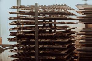 A vast warehouse in the forestry industry, showcasing a plethora of wooden products, including boards and various timber items neatly organized in storage photo