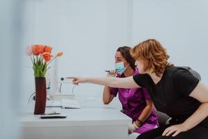 In a modern dental office, a dentist and a young patient engage in a collaborative consultation, exploring new tooth shades and discussing treatment options using a computer photo