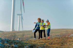 A team of engineers and workers oversees a wind turbine project at a modern wind farm, working together to ensure the efficient generation of renewable energy photo