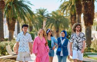 A diverse group of tourists, dressed in summer attire, strolls through the tourist city with wide smiles, enjoying their sightseeing adventure photo
