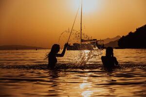 Group of female friends have a playful moment in the sea during sunset, their hair dancing in the wind, capturing their joyful bonding and carefree spirit by the beach photo