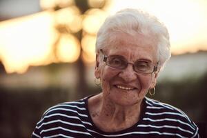 Unfiltered portrait, a real elderly woman sits gracefully in a chair, showcasing the authenticity of aging with wrinkles and a natural face photo