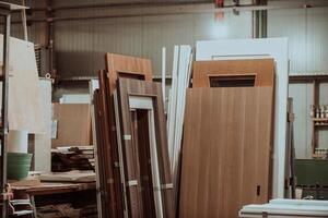 A vast warehouse in the forestry industry, showcasing a plethora of wooden products, including boards and various timber items neatly organized in storage photo