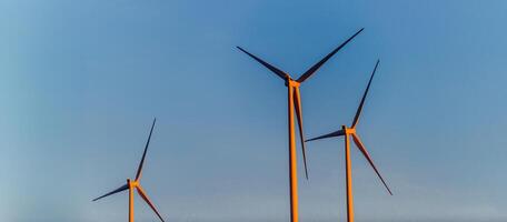 . A striking vista of modern wind turbines, stationed amidst the mountainous terrain, exemplifying the concept of conservation and harnessing natural energy resources photo