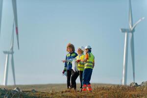 A team of engineers and workers oversees a wind turbine project at a modern wind farm, working together to ensure the efficient generation of renewable energy photo