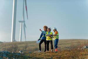 A team of engineers and workers oversees a wind turbine project at a modern wind farm, working together to ensure the efficient generation of renewable energy photo