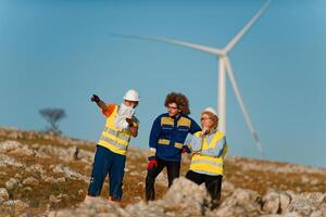 A team of engineers and workers oversees a wind turbine project at a modern wind farm, working together to ensure the efficient generation of renewable energy photo