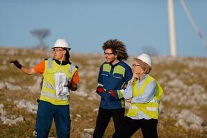 A team of engineers and workers oversees a wind turbine project at a modern wind farm, working together to ensure the efficient generation of renewable energy photo