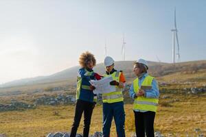 A team of engineers and workers oversees a wind turbine project at a modern wind farm, working together to ensure the efficient generation of renewable energy photo
