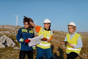 A team of engineers and workers oversees a wind turbine project at a modern wind farm, working together to ensure the efficient generation of renewable energy photo