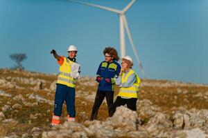 A team of engineers and workers oversees a wind turbine project at a modern wind farm, working together to ensure the efficient generation of renewable energy photo