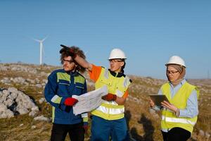 A team of engineers and workers oversees a wind turbine project at a modern wind farm, working together to ensure the efficient generation of renewable energy photo