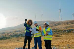 A team of engineers and workers oversees a wind turbine project at a modern wind farm, working together to ensure the efficient generation of renewable energy photo