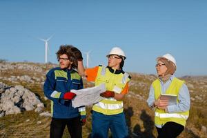 A team of engineers and workers oversees a wind turbine project at a modern wind farm, working together to ensure the efficient generation of renewable energy photo